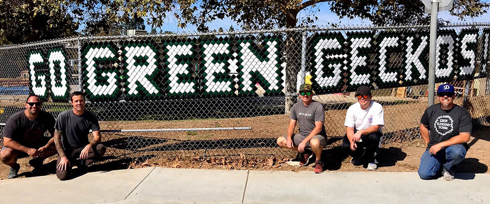 Gecko Dad's Club volunteers installing campus signage